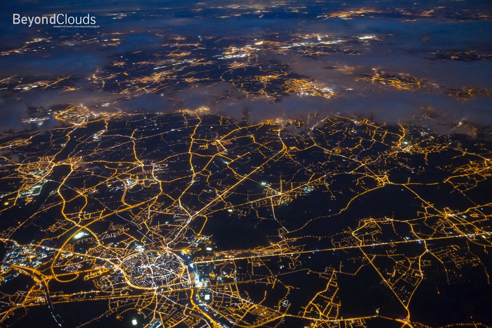 Like drawing a map. Flying over the state of Belgium during dusk show the massive network of roads.