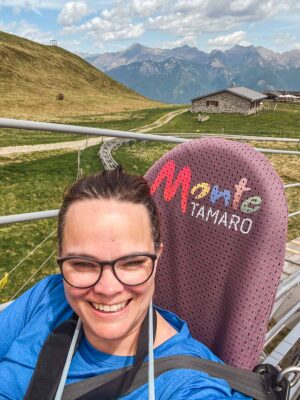 Woman riding on Monte Tamaro alpine coaster in Ticino, Switzerland